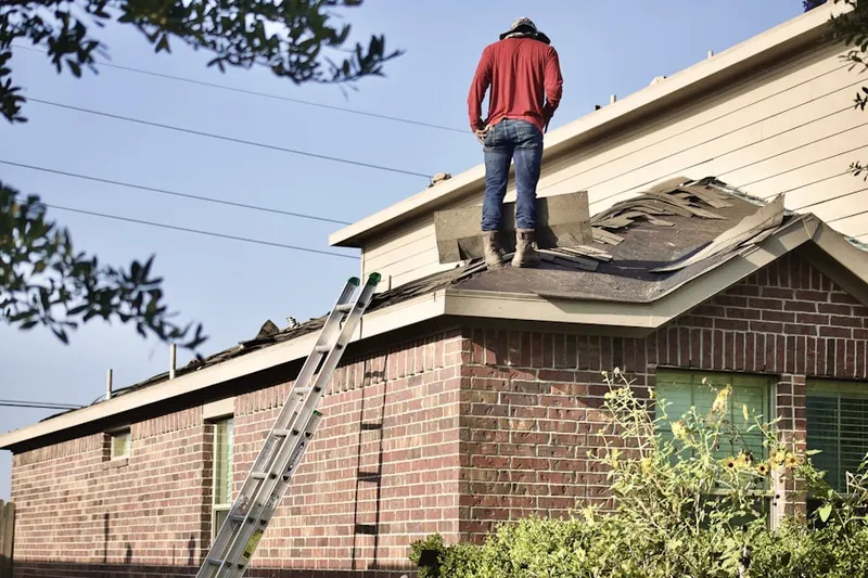 Professional roofer working on a residential roof in Brookshyre Woods